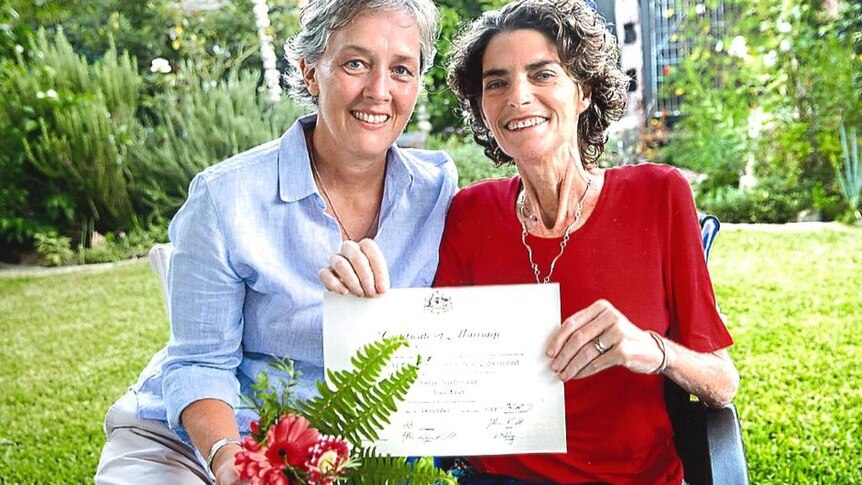 Jo Grant and Jill Kindt holding their marriage certificate