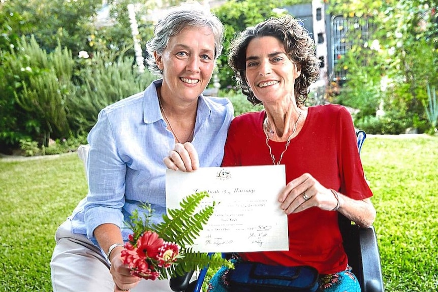 Jo Grant and Jill Kindt holding their marriage certificate