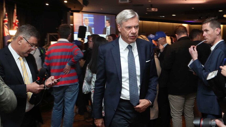 Victorian Liberal Party president Michael Kroger walks through the party's event on election night.