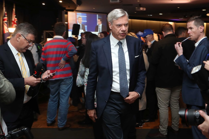 Victorian Liberal Party president Michael Kroger walks through the party's event on election night.