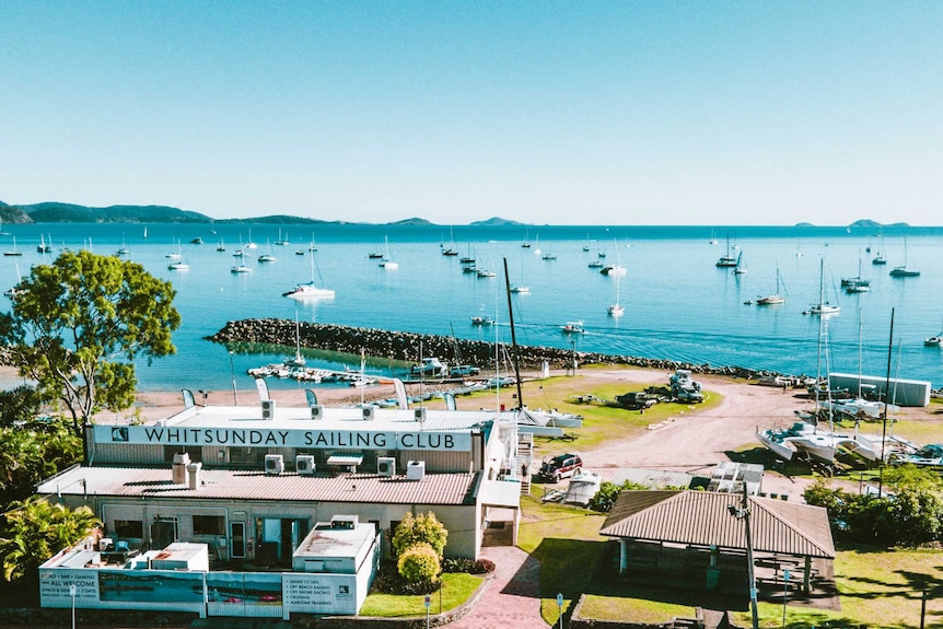 An aerial photo of the Whitsunday Sailing Club, showing the ocean and islands in the background.