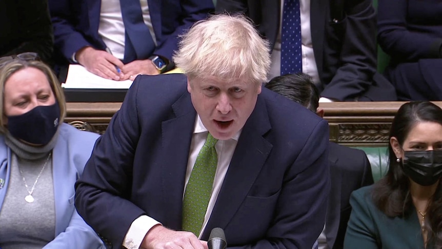 Boris Johnson speaks into a microphone in UK Parliament.