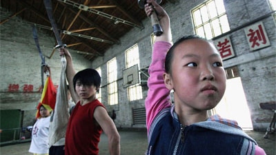 Children practise kung fu at a martial arts school in Xining of Qinghai Province, China, 2005.