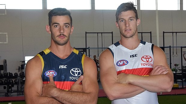 Crows players show off their new guernseys supplied by ICL