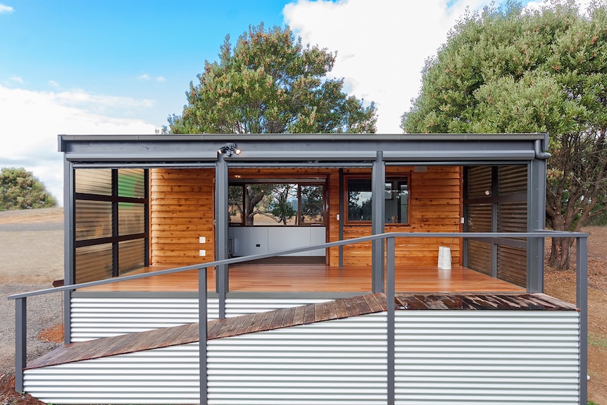 A tiny cabin made of wood and steel.