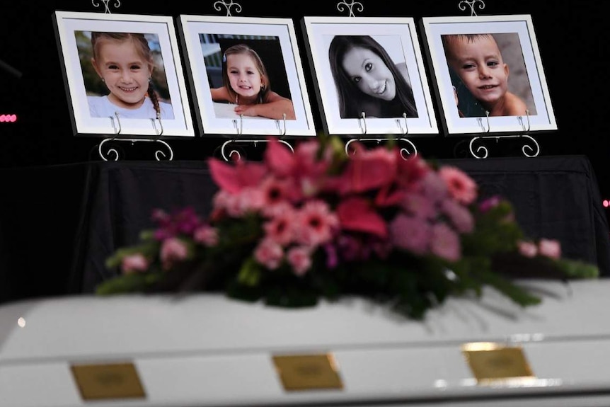 Picture frames with faces of a woman and children in a room