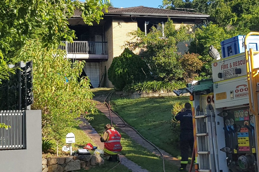 Firefighters outside an Everton Hills home in which three people died when a fire broke out.