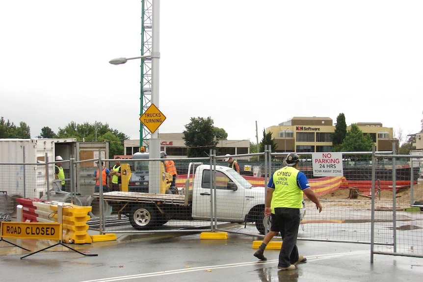 CFMEU official enters a building site at Acton in Canberra's city centre.