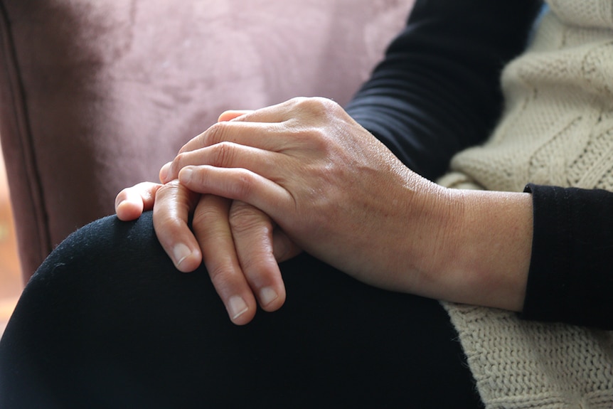 Close up of female clasped hands.