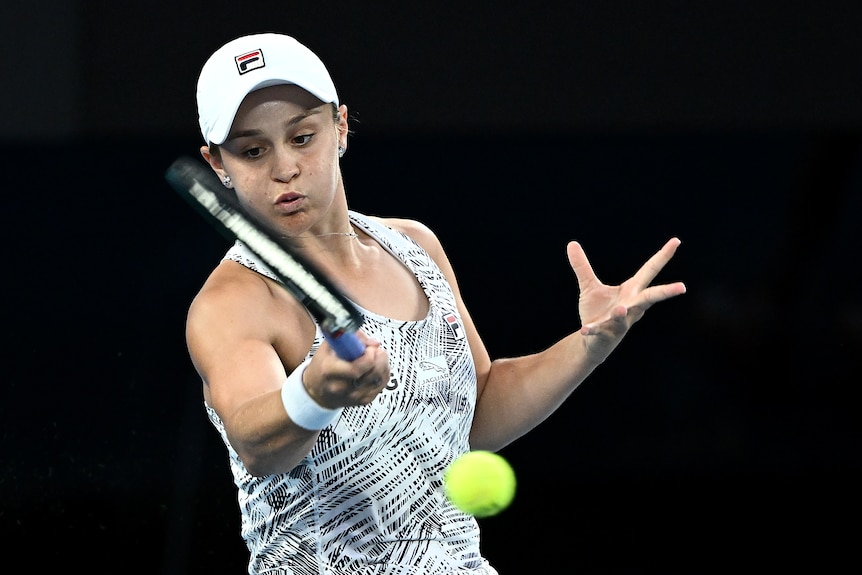 An Australian female tennis player hits a forehand.