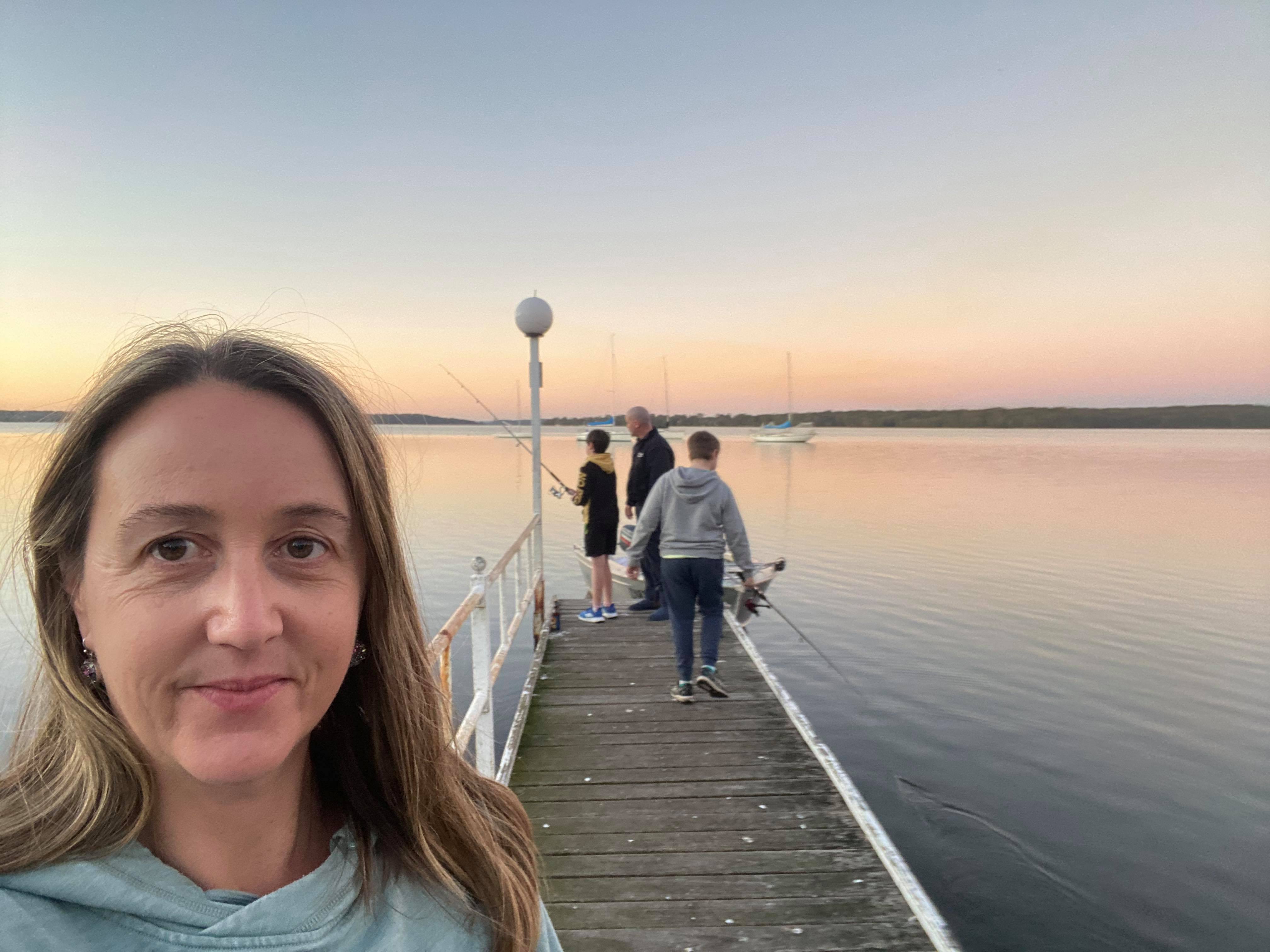 Amanda takes a selfie with her family in the background in a story about home and contents insurance.