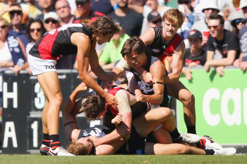 Essendon and Carlton players get in a scrap