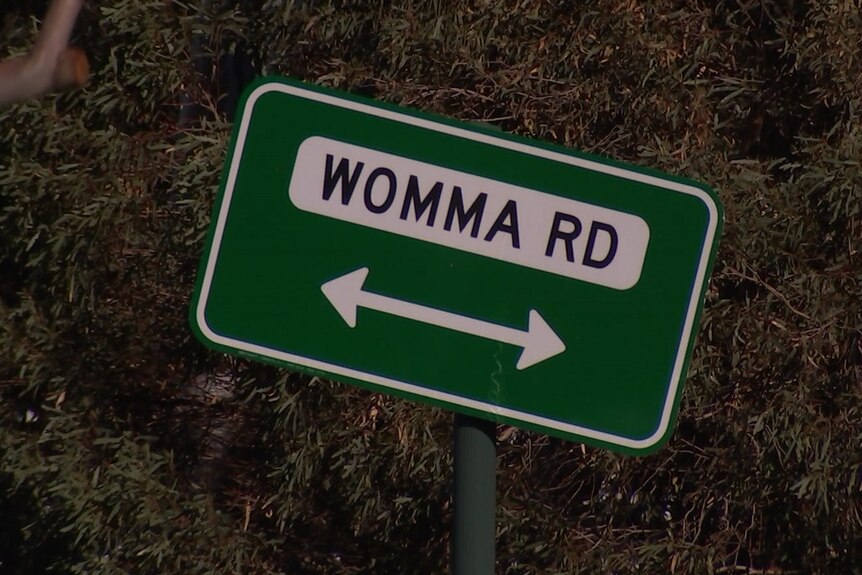 A sign saying WOMMA RD