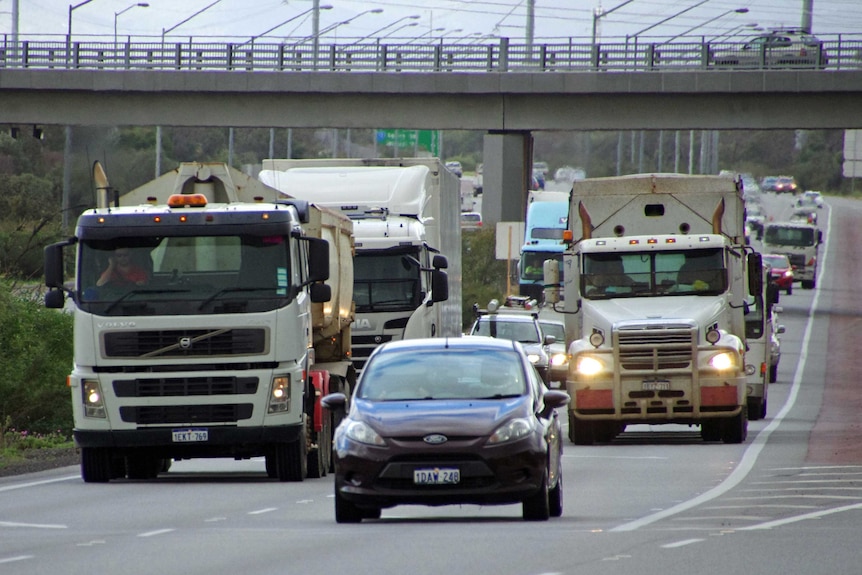 Busy traffic including trucks and cars on Roe Highway.