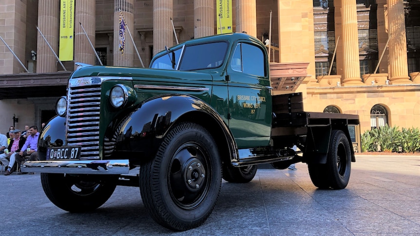 A green Chevy truck parked outside Brisbane City Hall