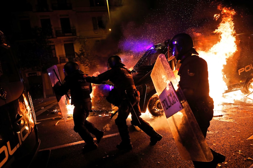 Police at burning barricade