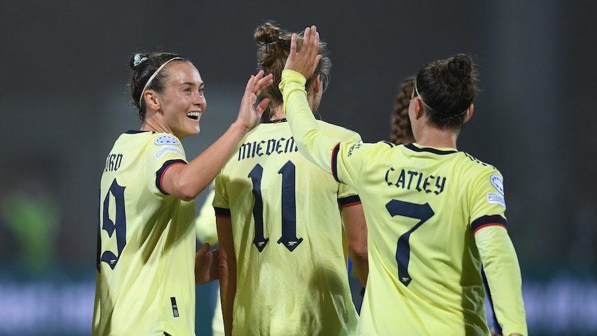 Arsenal's Caitlin Foord and Steph Catley celebrate after a goal.