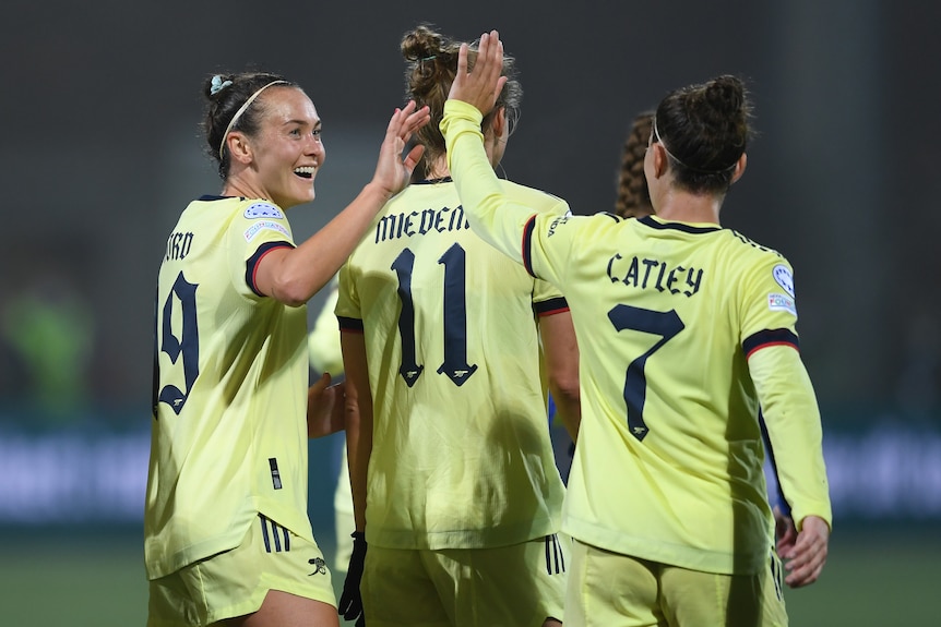 Arsenal's Caitlin Foord and Steph Catley celebrate after a goal.