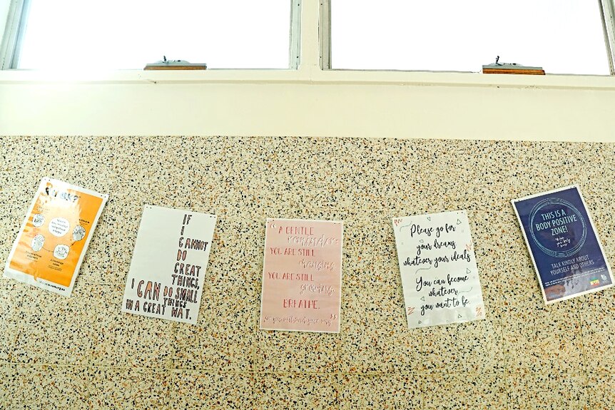 Motivational posters strung up on one of the walls in the girls bathroom at Penola High School.