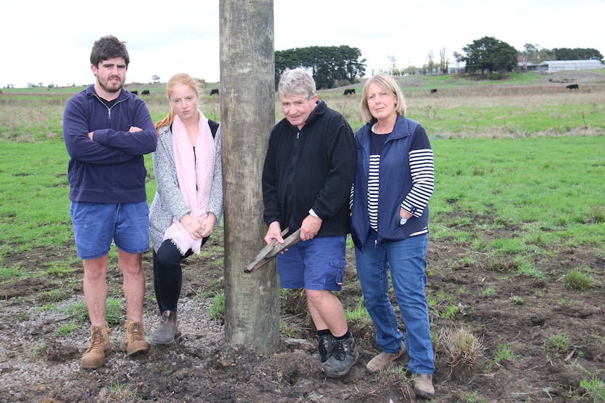 The Kenna family stand in a paddock on their farming property, from left to right: Jack Jr, Brigid, Jack Snr and Betty.