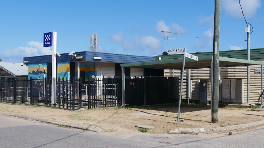 A rural Queensland police station with artwork on the exterior walls.