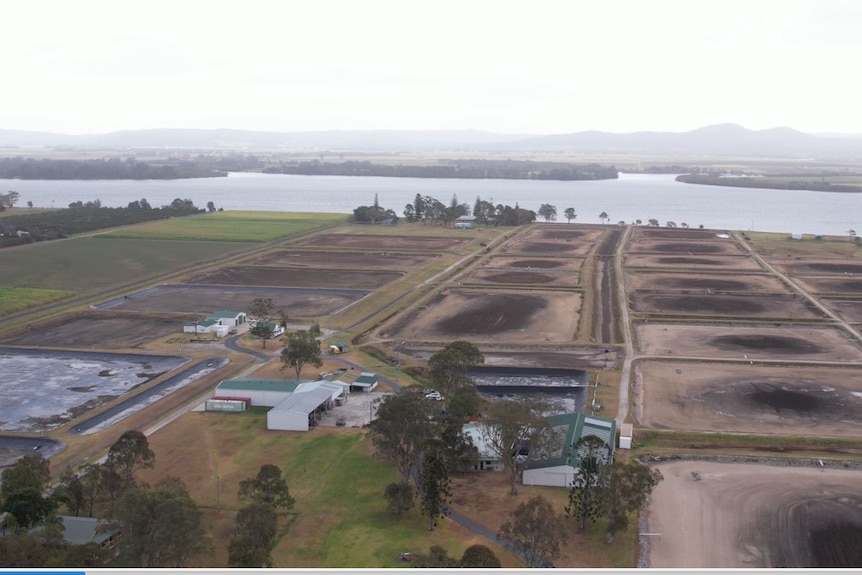 aerial shot of multiple ponds without water, Clarence River in the background