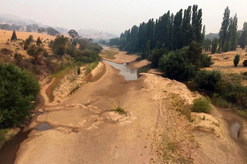 A dry riverbed with only small trickles of water.