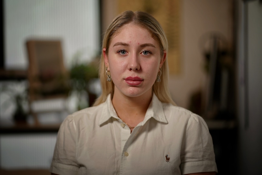 Blonde woman stares at camera