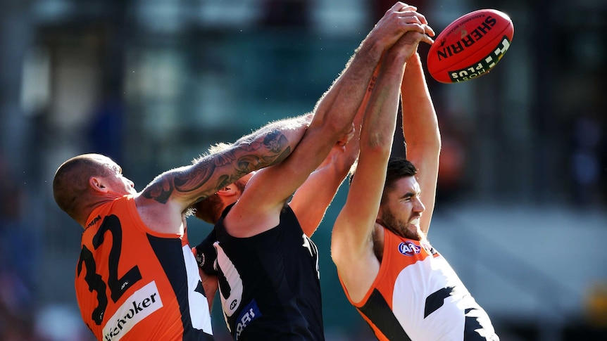 GWS and Carlton players contest the ball