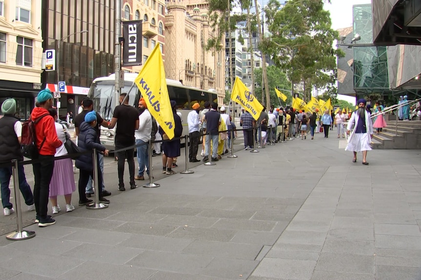 A queue of people holding pro-Khalistan flags