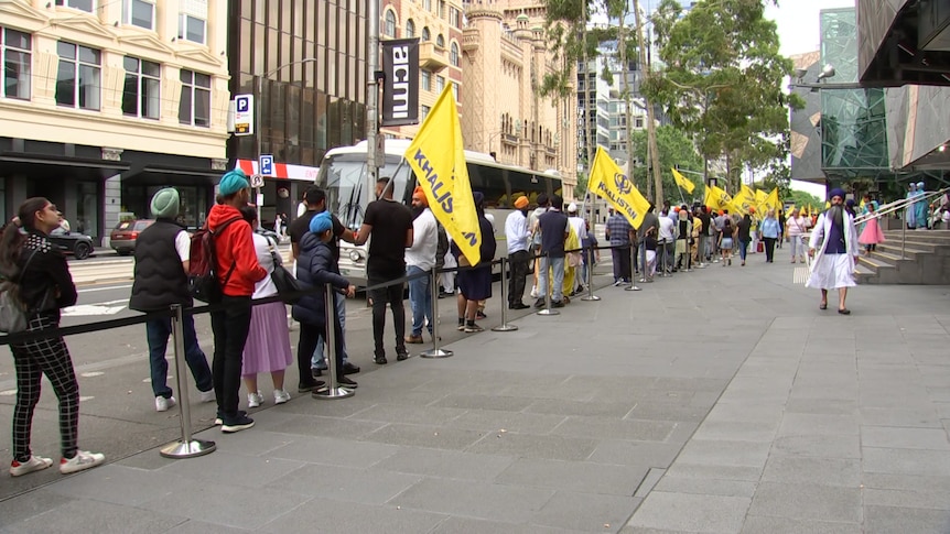 A queue of people holding pro-Khalistan flags