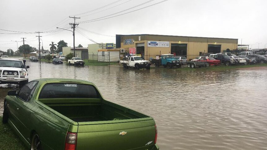 Cars and buildings in flooded Camuglia Street in Garbutt in Townsville.