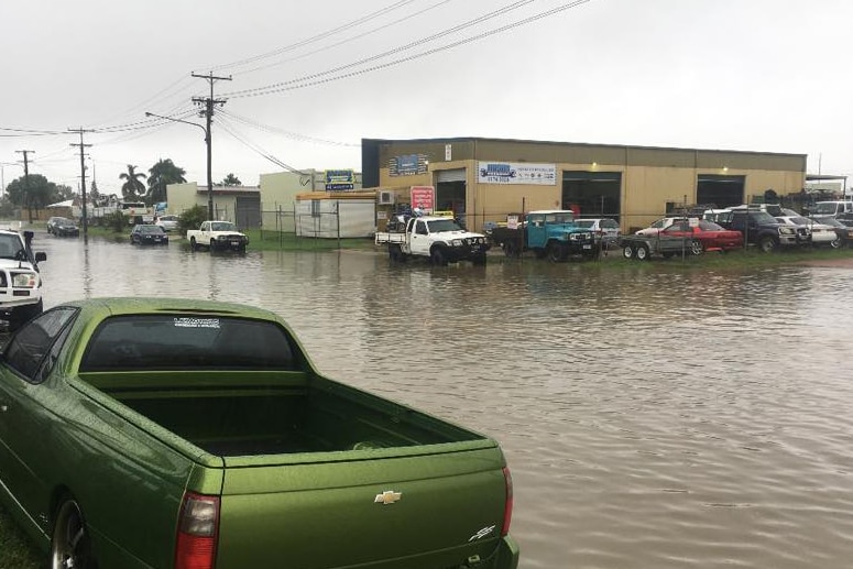 Cars and buildings in flooded Camuglia Street in Garbutt in Townsville.