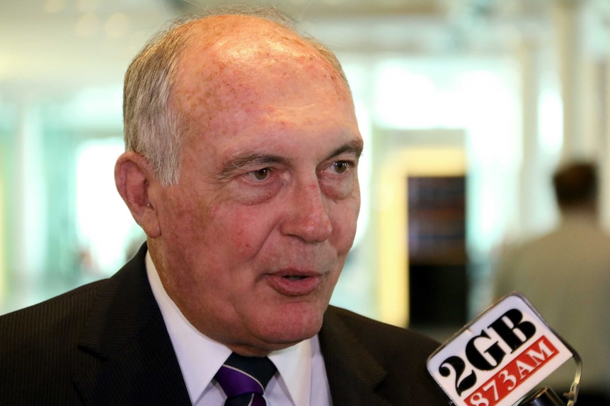 Warren Truss speaking to reporters.