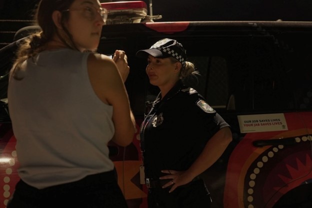 ABC journalist Kirstie Wellauer with police officer in Mount Isa in 2023