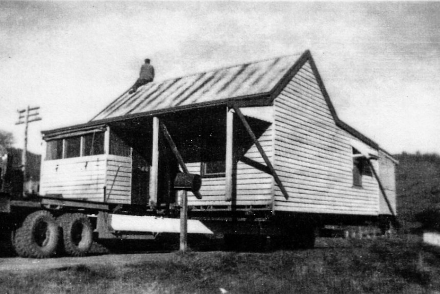A house on a truck, black and white photograph