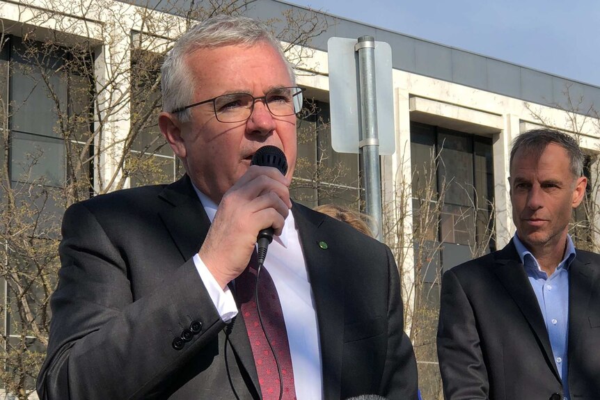 Andrew Wilkie speaks into a microphone outside the ACT Magistrates Court.