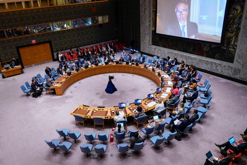 Rafael Mariano Grossi speaks to the United Nations Security Council from a large screen via video link.