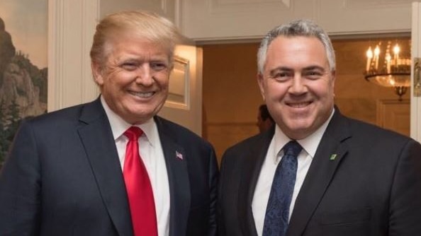 Mr Trump and Mr Hockey are both smiling. Mr Trump wears a red tie, while Mr Hockey wears blue.
