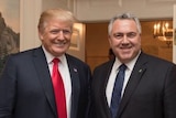 Mr Trump and Mr Hockey are both smiling. Mr Trump wears a red tie, while Mr Hockey wears blue.
