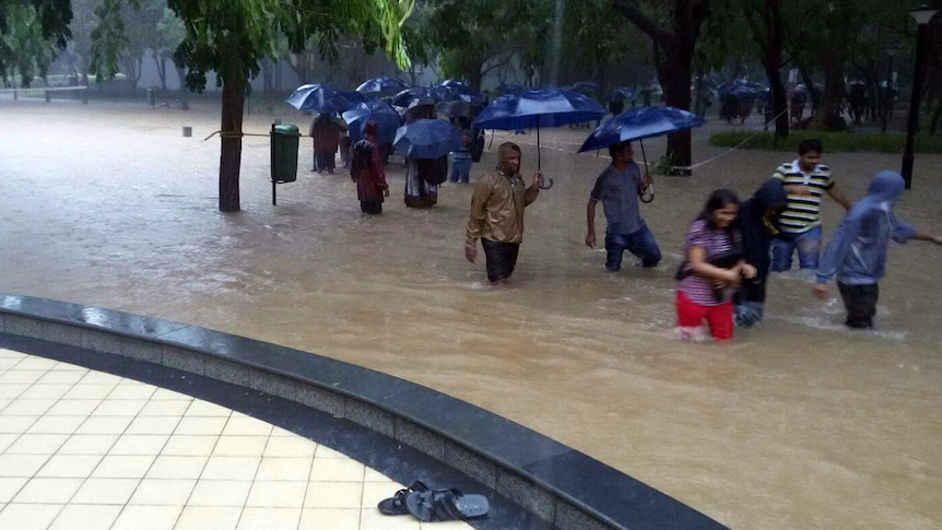 Employees trying to get to work during Indian monsoon