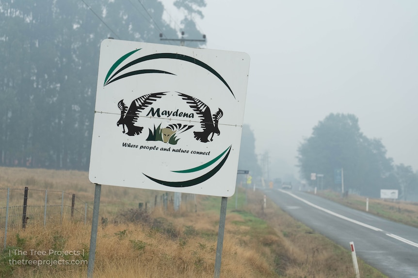A town sign covered in smoke.