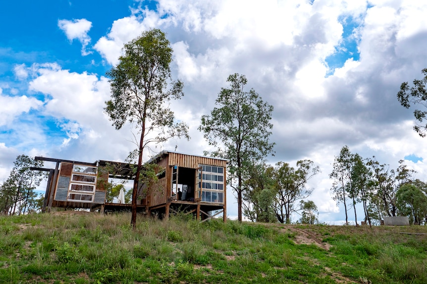 A timber rustic cabin in a Queensland bush setting.