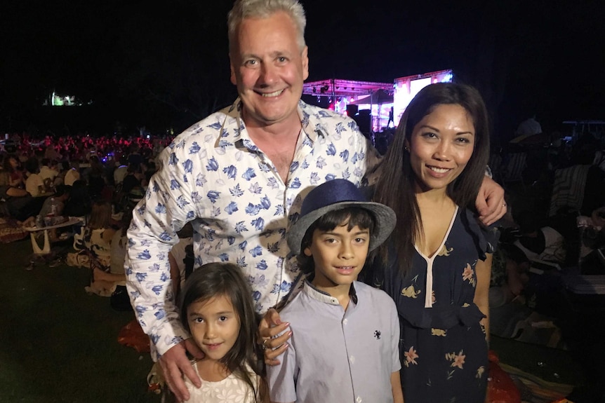Alex Gardener, wife Ahu, daughter Sophie and son Ben pose for a picture in front of a crowd.