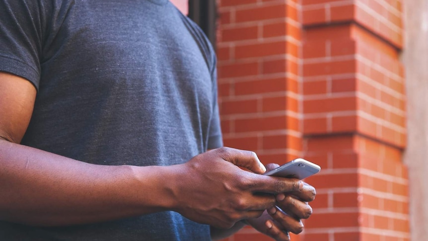 A man on a mobile phone for story about male victims of revenge porn.