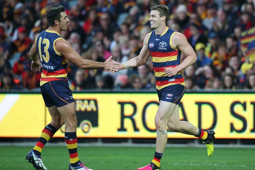 Josh Jenkins and Taylor Walker celebrate against St Kilda