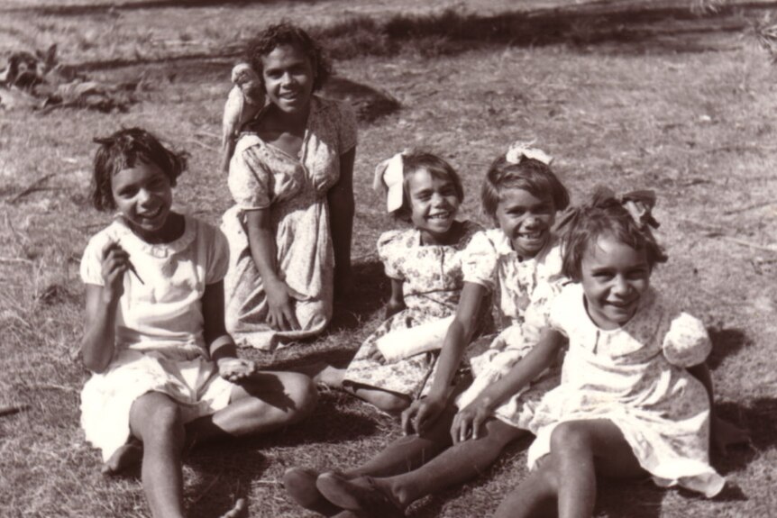 A black and white photo shows five girls.