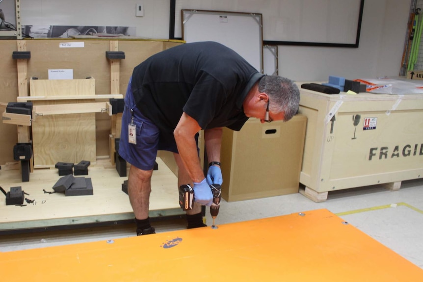 Pete Faulkner sealing the lid of the crate carrying the Blaue map from Canberra to Sydney.