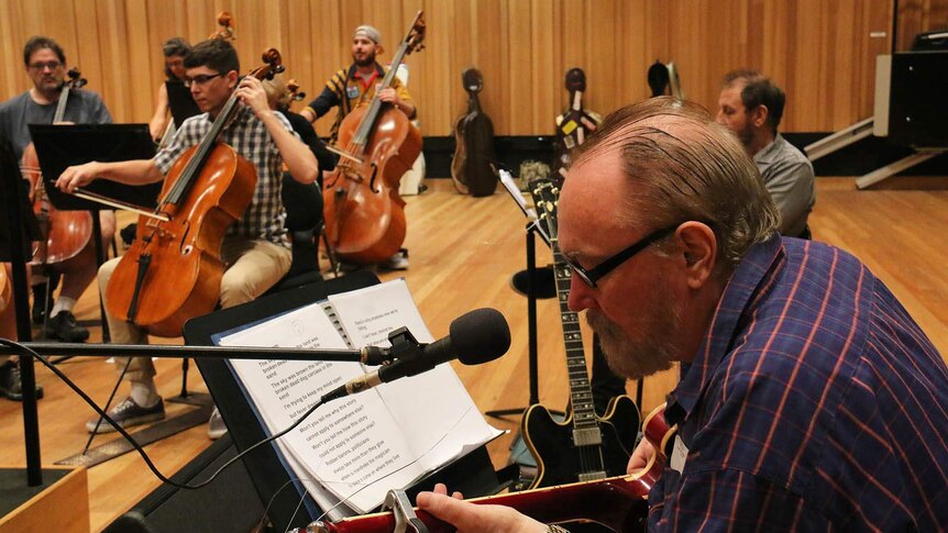 Ed Kuepper playing guitar and singing with the QSO in rehearsal