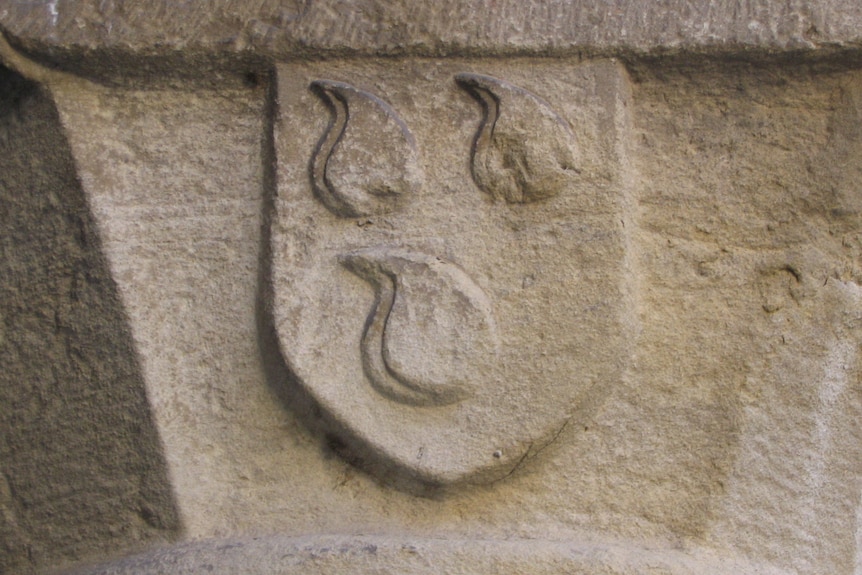 Medieval European stone heraldry showing three sets of testicles. 